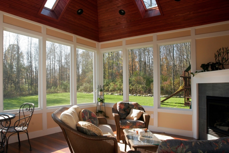 The screened porch is as comfortable as an indoor room, but open to the family’s private back yard.