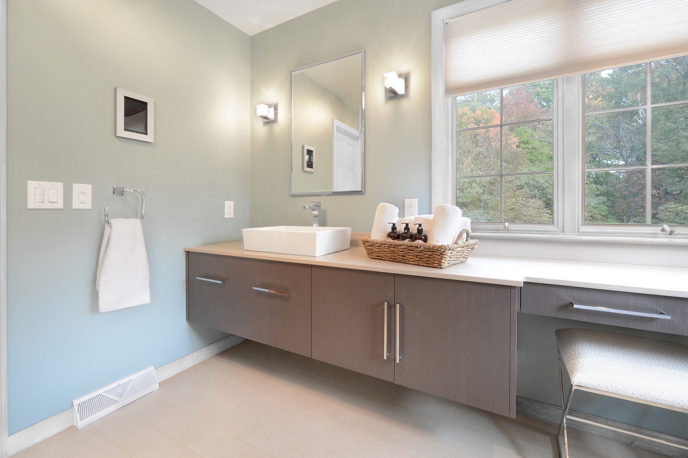 A vessel sink and a floating vanity complete the spa look. Bathroom renovation by Saratoga Springs bathroom remodeler and general contractor Teakwood Builders.