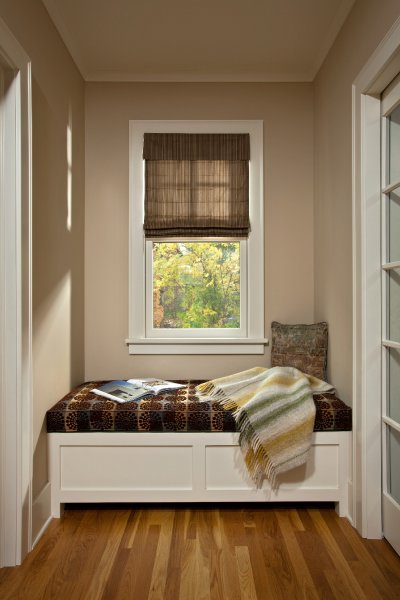A cozy window seat with storage concealed by the hinged bench top is tucked neatly between a mudroom entry and new powder bath in this historic Albany home renovated by Teakwood Builders of Saratoga Springs, NY.