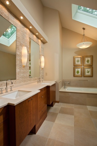 Teakwood Builders, a general contractor and home remodeler in Saratoga Springs, applied long clean lines while designing the remodel for both the kitchen and bath, giving the space a modern, airy, peaceful feel.