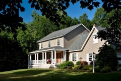 Teakwood Builder's addition of a front porch to this 1915 center hall Colonial Revival in Ballston Lake, NY, did wonders to revive the grandeur of the home and the family’s enjoyment of it. The new porch features mahogany decking, an edge and center bead fir ceiling, architectural columns, custom-milled rails and balustrade and a wooden entry door system.