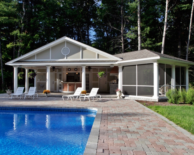 Inspired by a Grecian structure overlooking blue water, this homeowner asked Teakwood Builkders for a Mediterranean idyll in his own backyard. Set a distance from the main house, the pool house is decidedly Greek Revival with gable end returns, pediments and columns.