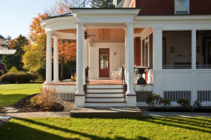 Substantial columns and wide steps with mahogany treads establish the home’s new rear entry access. The screened porch to the right – also new – features fine panels and pilaster details on the exterior that are repeated within the room, glimpsed here through the screen.