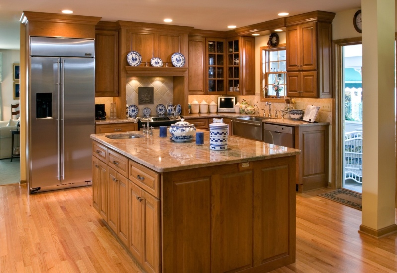 Cabinet facing hides the range hood and matches the full overlay raised panel cabinets.