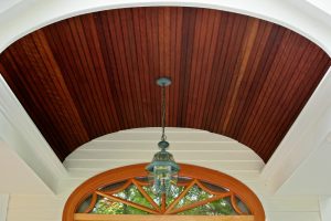 The line of the barrel vault perfectly echoes the transom window below it in this facade renovation by Teakwood Builders in Saratoga Springs.
