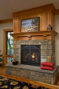 Indoor firplace at Adirondack lake home by Teakwood Builders, kitchen and bath remodeler, custom home builder and general contractor Saratoga Springs and Capital Region