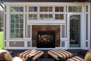 porch view of double fireplace by Teakwood Builders, kitchen and bath remodeler, custom home builder and general contractor Saratoga Springs and Capital Region