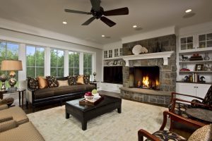 A floating white wooden mantel lightens the gravitas of the heavy stonework Teakwood Builders, kitchen and bath remodeler, custom home builder and general contractor Saratoga Springs and Capital Region