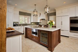 Custom panels help the French-door Sub-Zero 42-inch refrigerator and dishwasher blend with the cabinetry. To create an entertaining area separate from the cooking zone, the clients opted for a bar across from the breakfast table.